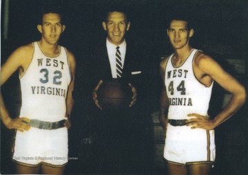 West (No. 44) poses on the right with West Virginia University basketball coach Fred Schaus (center) and Willie Akers (left). 