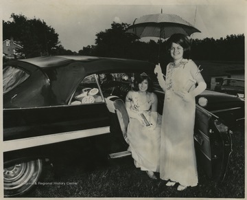 Fifteen-year-old Judy Kennedy, seated in the car, was crowned Miss 'Pioneer Days' after competeing with eight other contestants at the festival. She was a student at Morgantown High School and daughter of Mr. and Mrs. Elswood Kennedy.Also pictured is the first runner-up in the queen contests, fifteen-year-old Brenda Dalton, daughter of Mrs. and Mrs. Gay Dalton.