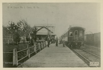 This image is part of the Thompson Family of Canaan Valley Collection. The Thompson family played a large role in the timber industry of Tucker County during the 1800s, and later prospered in the region as farmers, business owners, and prominent members of the Canaan Valley community.The image shows the Western Maryland train Depot No. 2 with passengers waiting for a train.