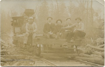 Men pose for a portrait while transporting lumber on a railroad, likely in Tucker County, W. Va.This image is part of the Thompson Family of Canaan Valley Collection. The Thompson family played a large role in the timber industry of Tucker County during the 1800s, and later prospered in the region as farmers, business owners, and prominent members of the Canaan Valley community.