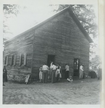 A group of church goers are gathered outside of the church, which was established in the Rock Gap District in 1797. The chapel had a greater influence on rural religion and in the spread of the German Evangelical movement than any other in Morgan County, W. Va. For years, the German preachers of the United Brethren shared the chapel with English Methodist preachers, often conducting services in both the English and German languages. 