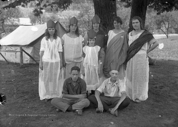 A group of boys and girls are dressed in costume. Subjects unidentified. 