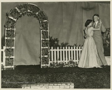 A couple dances on stage. Subjects unidentified. 