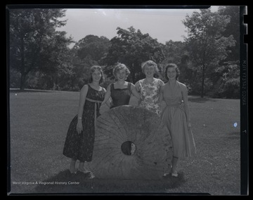 Four unidentified girls pose together. The photograph is captioned, 'Girl's nation.'