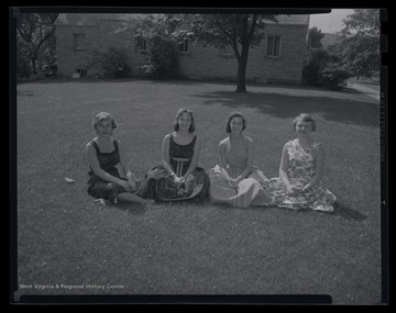 Four unidentified girls are pictured on a lawn. The photo caption reads, 'Girl's nation.'