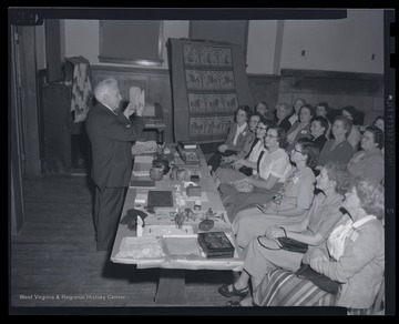 Eaton, left, speaks to a large group of women. 