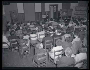 Eaton speaks to a large group of women. 