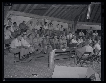 A group of dairymen meet together during the exhibit.