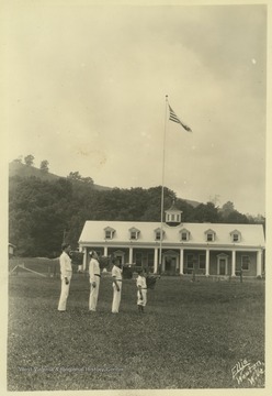 Four boys play their bugle instruments outside of the State 4-H Camp building. Subjects unidentified. 