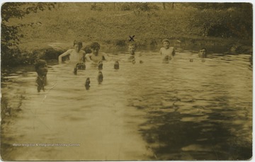 Miller, marked on the photo with an "x", swims with his friends in the river. 