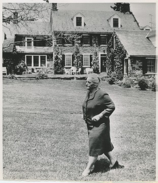 Pearl S. Buck walking across the lawn at her home in Doylestown, Pa.
