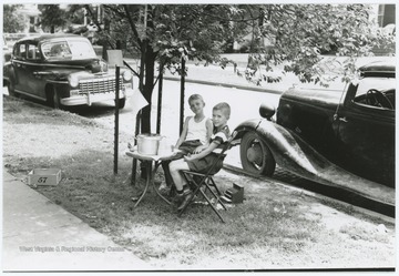 Miller Murrell, probably on left, and Danny Gardner hold a Kool-Aid stand outside the Murrell home at 309 Ballengee Street, Hinton, W. Va.
