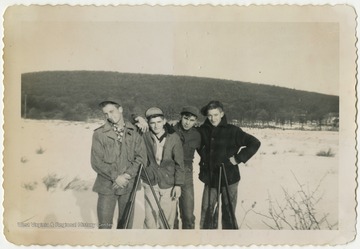 Terra Alta High School students Paul Cooper, Richard Fraley, Clifford Lambert, and "Weed" Arthur Sisler pose together during a hunting trip. 
