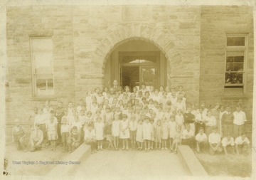Bryce Hildebrand is among the school children. One African-American child is standing on the far left. 
