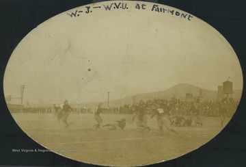 West Virginia University Mountaineers face the Washington and Jefferson football team as spectators watch from the sidelines. West Virginia University won the game, 7-0, which took place in Fairmont, W. Va.