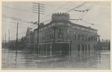 Photo postcard of an unidentified building during a 1913 flood. Postcard is part of a souvenir book of 1913 flood images.