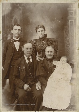 Samuel F. Harsh is pictured sitting down beside his wife, Louisa, who is holding baby Goldie Claire. Standing in the background is William and Alice Kidwell.Harsh was a home guard at Phillippi, W. Va. during the Civil War and owned a Blacksmith shop. He and his wife moved to Davis around 1890.J. William Kidwell worked for Babcock Lumber Co. and Blackwater Coal Co. 