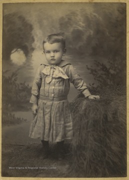 A young Morton is pictured inside A. M. Slusher's photo studio. 