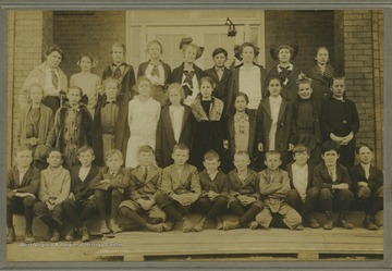 A group of school children, one being a McMillan family member, are gathered for a class photo. 