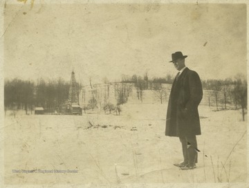 Al Cox is pictured in the forefront while gas is drilled in the background. 