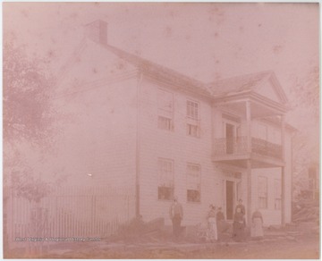 Building in picture built shortly after 1855. Subjects in photo are identified as William Lantz, his wife Sarah Thomas, their son Ellis Pierce Lantz's wife Ida Johnson, and their daughter "Sallie".