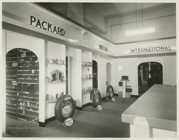 Interior of an automotive store featuring parts and accessories for Packard, Hudson, and International vehicles.  Likely in Morgantown, W. Va.