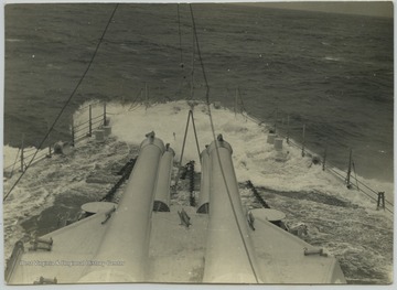 The battleship's deck is briefly flooded by seawater.