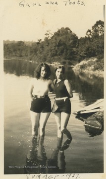 Two women, identified as Gara and Toots, pose in the Cheat River, likely in Preston County.
