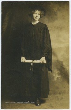 A Weltner relative poses in her cap and gown while holding a diploma.