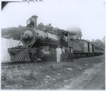 Four unidentified man pose beside engine number 201. 