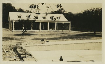 Dining hall at Jackson's Mill State 4-H camp and pool construction on the lawn.  The pool was completed in the summer of 1925.
