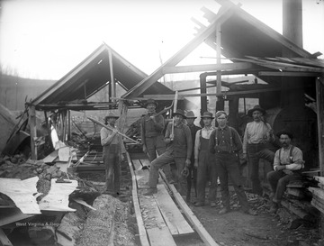 A group of men are picture beside a sawmill and furnace. The sawmill is located in the Good Hope area, which crosses over into Harrison County. Subjects unidentified. 