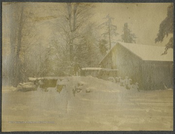 Winter scene at a Somerset County sugar camp, where sugar and syrups are produced.This photograph is found in a scrapbook documenting the survey for the B. & O. Railroad in West Virginia and surrounding states. 