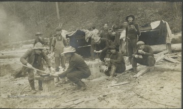 Surveyors for the B. & O. Railroad gather for their morning meal.This photograph is found in a scrapbook documenting the survey for the Baltimore and Ohio Railroad in West Virginia and surrounding states. 
