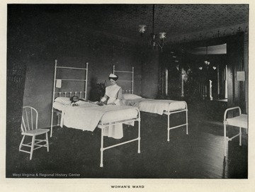 Woman's Ward in the New City Hospital of Morgantown, W. Va.  At the foreground, a nurse stands with a patient.