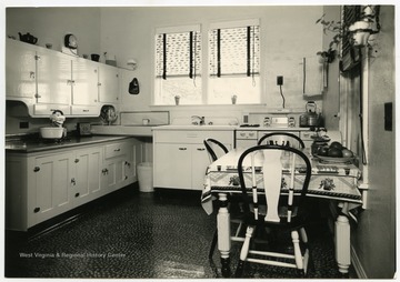 Kitchen of a 4-H model home. On display are an electric mixer, toaster, and other small appliances.