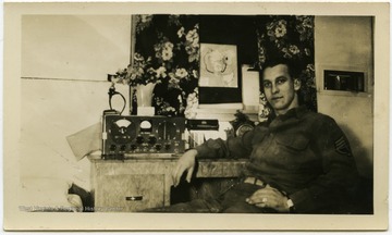 Melvin H. Kimble at his desk with radio before the Battle of the Bulge.