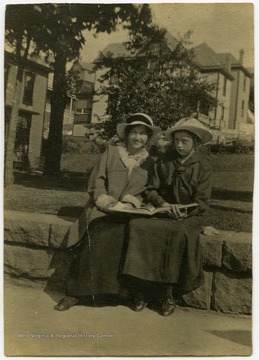 Carrie Harper Harman (on right) and unidentified woman looking at a book.