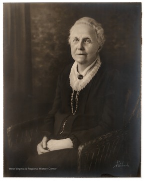 Portrait of Elizabeth Irwin Moore.  Moore, who was married to James Robertson Moore, was the principal of Woodburn Female Seminary before the building and land were incorporated into the campus of West Virginia University.  She later opened Morgantown Female Seminary on High Street.Elizabeth Moore Hall on the Morgantown campus of West Virginia University was named in her honor shortly before her death in 1930.