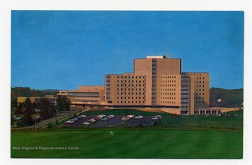 Reverse reads: "The West Virginia University Medical Center, with the Basic Sciences Building on the left and the University Hospital on the right, is one of the finest and most modern medical centers in the world. There are 3,412 rooms in this single structure."