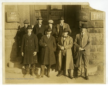 Front left to right: John W. Smith (Member of committee), James W. Carskadon (President), Nat T. Frame (Director of Extension), J. Blaine McLaughlin (Secretary).Back left to right: Dale Curry (Member of Committee), Izetta Jewell Brown (Member of Committee), Albert Leatherman (Member of Committee)."In front of the warehouse in Clarksburg where space had just been secured for the West Virginia Farm Bureau Wool Pool of 80,000 lbs. in 1922."