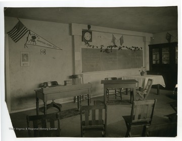Room with chalk board and desks set up for Woman's Club meetings.
