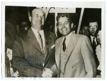 Text on back reads, "Louis A. Johnson, left, of Clarksburg, West Virginia, being congratulated by his predecessor Henry L. Stevens, after his election as national commander of the American Legion at the Portland, Oregon convention."