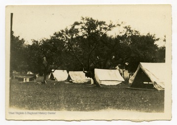 A row of tents in a field.