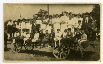 Members perch on a horse-drawn wagon