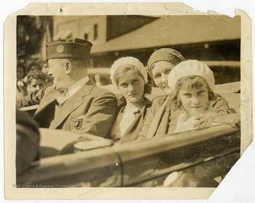 Louis Johnson pictured in a car with his wife Ruth Frances Maxwell Johnson and his daughters Lillian Maxwell Johnson and Katherine Ruth Johnson, likely during his tenure as National Commander of the American Legion. 