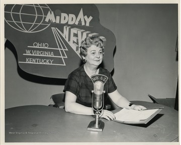 "Katie Doonan shown at her studio where she announced the dates that abundant agricultural commodities would be distributed to the needy in the Charleston area. The stepped-up distribution of food was caused by President Kennedy's Executive Order Number 1, which added protein foods to the list of commodities being distributed." United States Department of Agriculture Office of Information. 