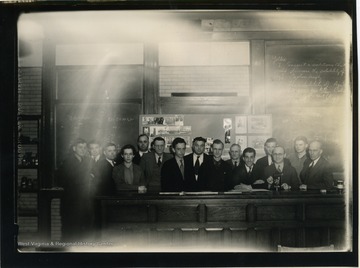 WVU students and faculty pose in classroom.  The group appears to be a chemistry class.