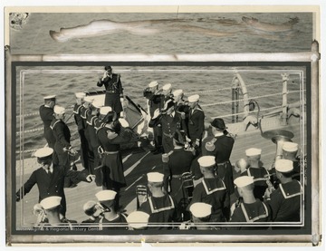A naval band welcomes Vice Admiral Henry A. Wiley aboard the U.S.S. West Virginia, a super-dreadnought in commission during WWII.