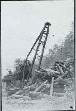 Photograph from "The Hardwood Bark," a periodical journal published by the W. M. Ritter Lumber company in the interest of its employees.This image is on a page with several other photos titled "In Hazel Creek Woods." The caption for this photo reads:"4.Hazel Creek skidder in action, with A. Crowder in charge."